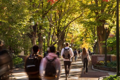 Students walk through campus in the fall.